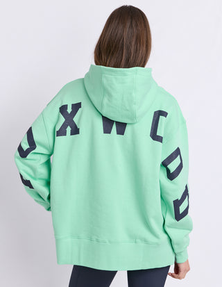 Mint green Foxwood oversized hoodie with large black graphic lettering on the back.
