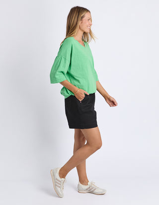 Elm Mazie Vee Neck Meadow Green, Side profile walking view | AAAG