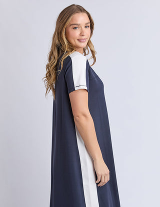 Woman wearing a navy blue and white short sleeve casual maxi dress