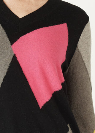 Black v-neck knit sweater featuring a large pink geometric pattern and grey sleeves.
