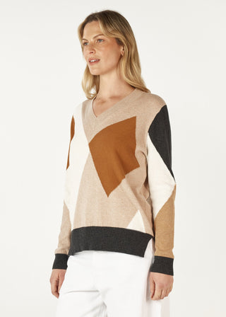 Woman wearing a geometric pattern V-neck knit sweater in beige, brown, and black.