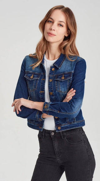 Woman wearing a blue denim jacket over a white t-shirt and black jeans.