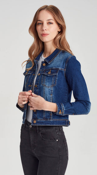 Woman wearing a classic blue denim jacket and black jeans.