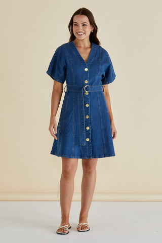 Woman wearing a short-sleeved blue denim button-down dress with a matching belted waist.