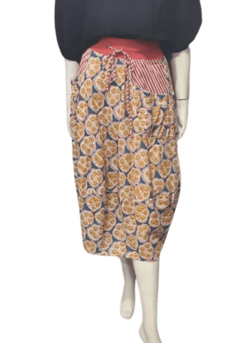 Woman wearing a patterned midi skirt with red waistband and striped pocket detail
