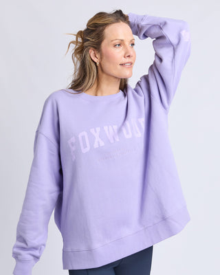 Woman wearing a lilac Foxwood oversized sweatshirt against a plain white background.