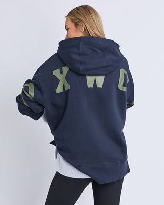 Close-up of khaki Foxwood logo on navy Interval Hoodie