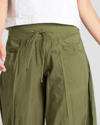Close-up of women's olive green drawstring wide leg leisure pants.