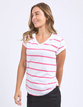 Woman wearing a white and pink striped V-neck short sleeve t-shirt.