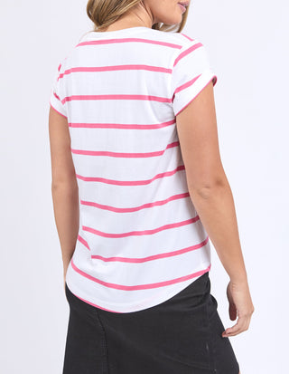 Woman wearing a white and pink striped short sleeve t-shirt and black skirt.