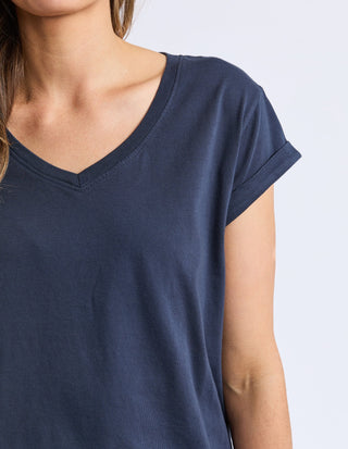 Woman wearing a navy blue v-neck short sleeve t-shirt