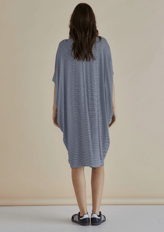 Back view of a woman wearing a navy and white striped oversized T-shirt dress.