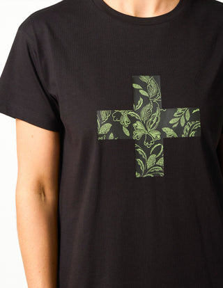 Black cotton t-shirt featuring a green floral print cross graphic on the front.