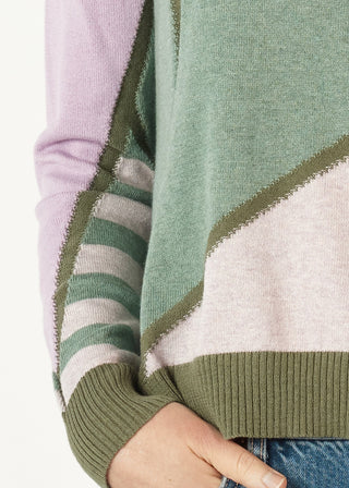 Multi-colored patchwork knit sweater in pastel pink, green, and lavender tones.