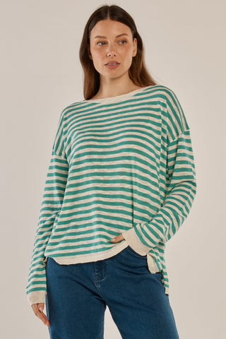 Woman wearing a teal and cream striped long sleeve lightweight sweatshirt and blue jeans.