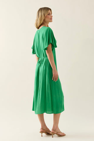 Woman wearing a green midi dress with flutter sleeves and a tie waist.