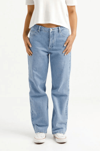 Woman wearing light wash wide leg blue jeans and a white t-shirt