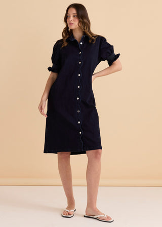 Woman wearing a navy blue denim button-down shirt dress with short puffed sleeves.