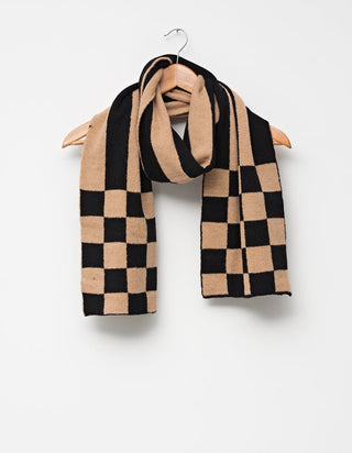 Black and tan checkered knit scarf hanging on a wooden hanger.