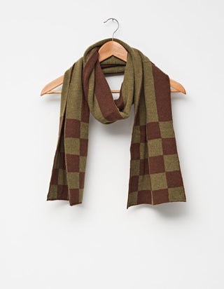 Olive green and brown checkered knit scarf hanging on a wooden hanger.