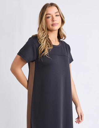 Woman wearing a charcoal grey short sleeve t-shirt dress