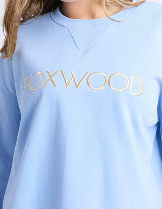 Light blue Foxwood sweatshirt with gold lettering