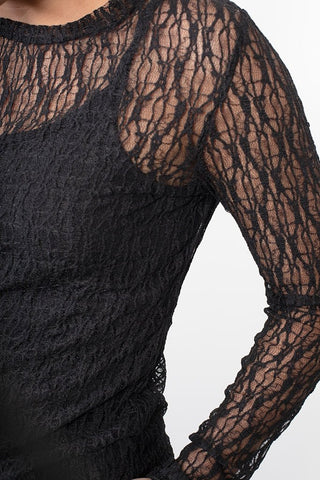 Black long sleeve lace top with intricate floral pattern over a matching camisole.