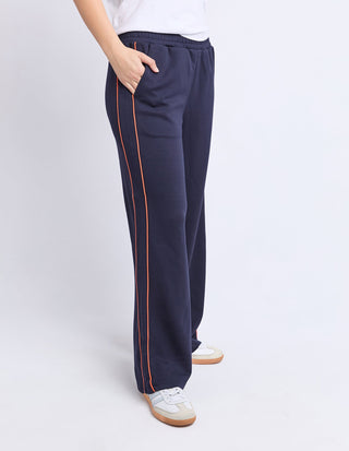 Navy blue wide leg lounge pants with orange side stripe detail