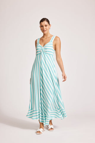 Woman wearing a turquoise and white striped maxi dress with a v-neckline.