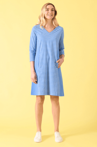 Woman wearing a blue and white striped V-neck midi dress with three-quarter sleeves.