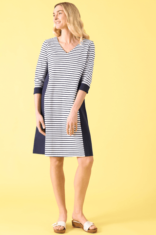 Woman wearing a navy and white striped V-neck midi dress with dark side panels.