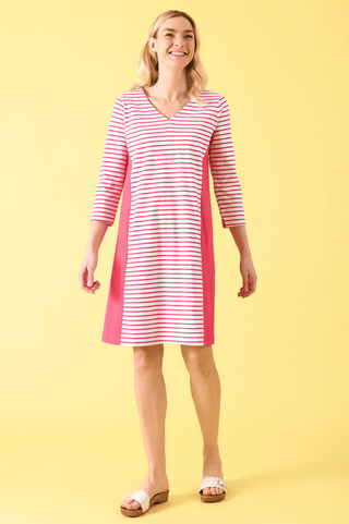 Woman wearing a pink and white striped V-neck dress with side panels