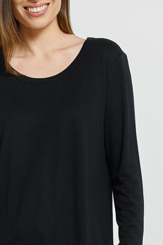 Close-up of a woman wearing a classic black long-sleeve scoop neck top.